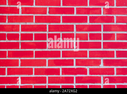 Red brick wall fragment, the texture of a brick wall painted red Stock Photo