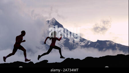 Running people athletes silhouette trail running in mountain summit background. Man and woman on run training outdoors active fit lifestyle. Stock Photo