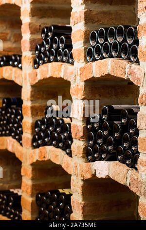 Many bottles in the vaulted cellar Stock Photo