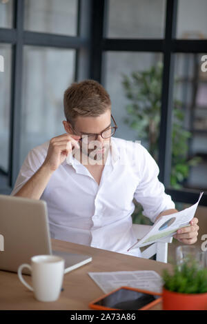 Businessman reading news and drinking coffee in the morning Stock Photo