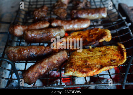 Meat on the grill, chicken steak, chicken liver and kebabs on hot grill, ready for the plate Stock Photo