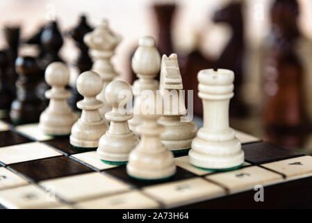 Close up of chessboard with classic wooden pieces with selective focus Stock Photo