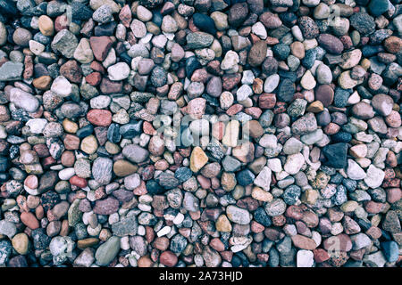 Full frame background of colorful sea stones on a Baltic coastline (vintage effect) Stock Photo