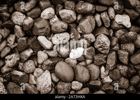 Full frame background - monochromatic sepia toned image of sea stones in close-up on a Baltic coastline ( vintage effect) Stock Photo