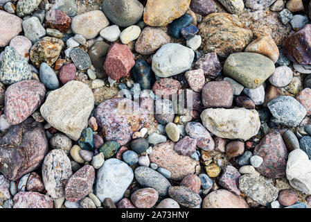 Full frame background of colorful sea stones in close-up on a Baltic coastline Stock Photo