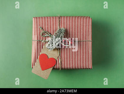 High angle view of gift box with greeting card for Valentine's Day isolated on green background Stock Photo