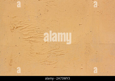 Texture of cracked yellow paint on an old plastered wall. A lot of cracks and scratches. Stock Photo