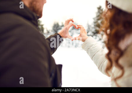 Man and woman making heart symbol with hands Stock Photo