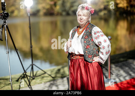 Portrait of a woman dressed in Ukrainian national dress as a well-known actress on the red carpet during awards ceremon Stock Photo