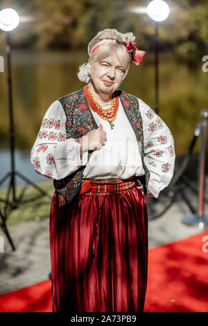 Portrait of a woman dressed in Ukrainian national dress as a well-known actress on the red carpet during awards ceremon Stock Photo