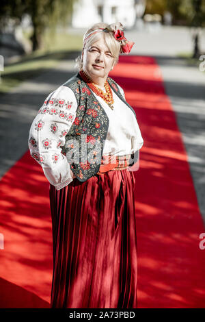 Portrait of a woman dressed in Ukrainian national dress as a well-known actress on the red carpet during awards ceremon Stock Photo