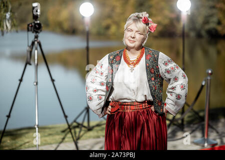 Portrait of a woman dressed in Ukrainian national dress as a well-known actress on the red carpet during awards ceremon Stock Photo