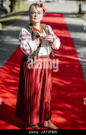 Portrait of a woman dressed in Ukrainian national dress as a well-known actress on the red carpet during awards ceremon Stock Photo