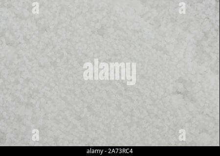 White granular background close up view. Wax small balls Stock Photo