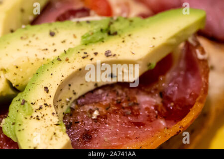 Bacon, avocado, cheese and tomato open sandwich Stock Photo