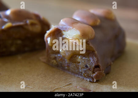 Food photography of a raw food chocolate bar with peanuts and caramel Stock Photo