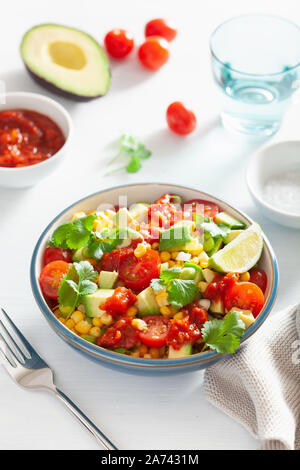 healthy vegan avocado sweetcorn tomato salad Stock Photo