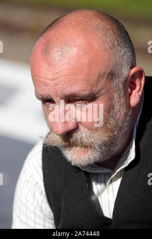 Upper body and head shot of an 50s something bearded and balding English Male. Stock Photo
