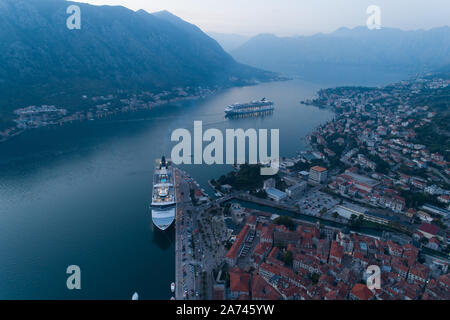 Kotor, Montenegro - October 28, 2019: cruise ships Norwegian Spirit and Norwegian Star are in port, aerial. Stock Photo