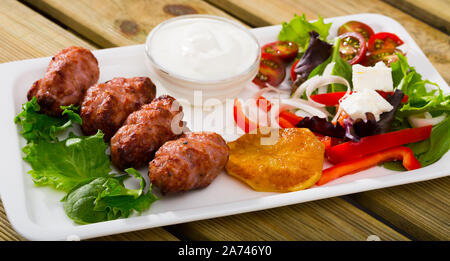 National Bulgarian dish Kebapcheta (grilled sausages) served with salad and green cheese Stock Photo