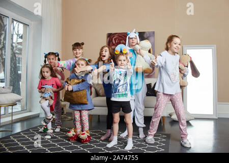 Large family, children have fun and play in the morning at home. Boys and girls in night pajamas, a friendly big family. Russia, Sverdlovsk, 10 March Stock Photo