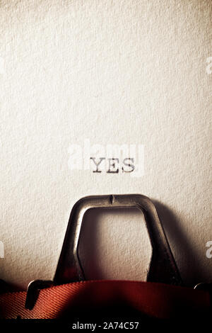 The word, Yes, written with a typewriter. Stock Photo