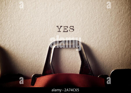 The word, Yes, written with a typewriter. Stock Photo