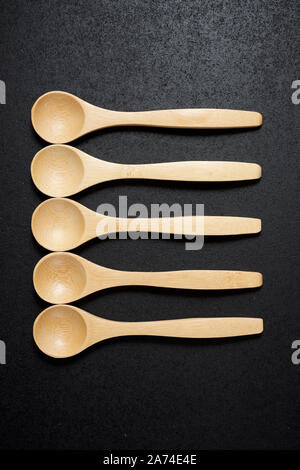 Wooden spoons on a black table. Stock Photo