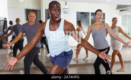 Group of multinational activity people practicing  dance techniques in modern studio Stock Photo