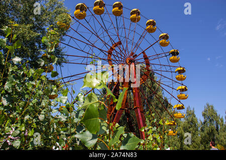 The abandoned Ferris wheel in the amusement park in Pripyat. Chernobyl nuclear power plant zone of alienation Stock Photo