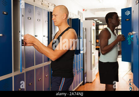 Two athletes in the locker room after training Stock Photo - Alamy