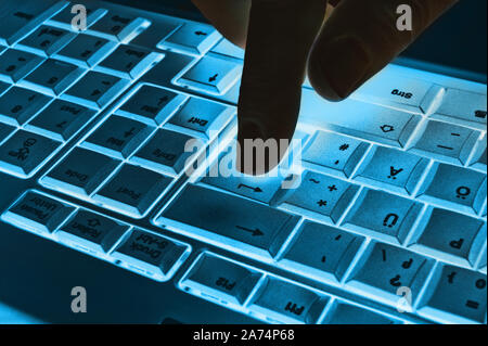 Keyboard close-up Enter key with finger Stock Photo
