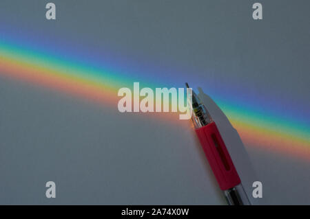 the rainbow of the light spectrum on head of pen Stock Photo