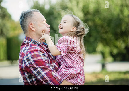 grandfather with granddaughter. Love you so much my grandpa. Grandpa kissing grandchild in thr park. Multi generation family enjoying in the park. Stock Photo