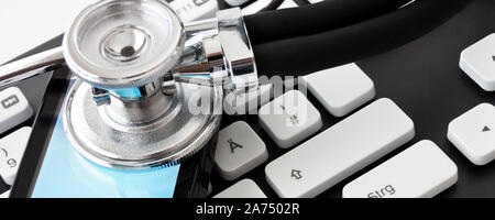 Keyboard with stehoscope and smartphone on white background close up Stock Photo