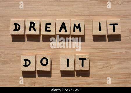 Dream It, Do It. Motivational words in 3d wooden alphabet letters on a bamboo wood background Stock Photo