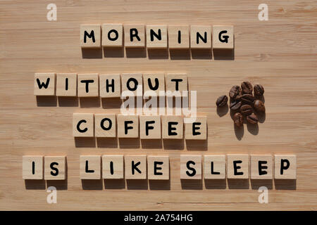 Morning Without Coffee is Like Sleep. Words in 3d wooden alphabet letters with coffee beans  on a bamboo wood background Stock Photo