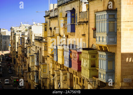 Colorful traditional Maltese balconies in Valletta. Street at sunny day Stock Photo