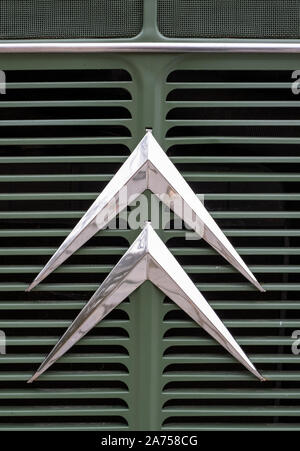 Retro Citroen logo on the front grille of a retro green Citroen van. Stock Photo