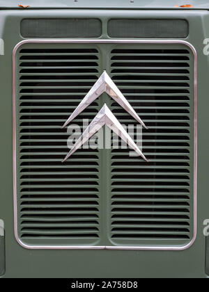 Retro Citroen logo on the front grille of a retro green Citroen van. Stock Photo