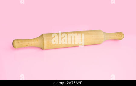 Kitchen utensils-rolling pin for rolling dough on pink background. Cooking tools. Stock Photo