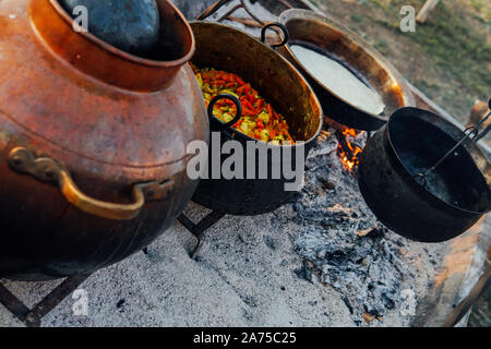Food in the cauldron is cooked on fire Stock Photo