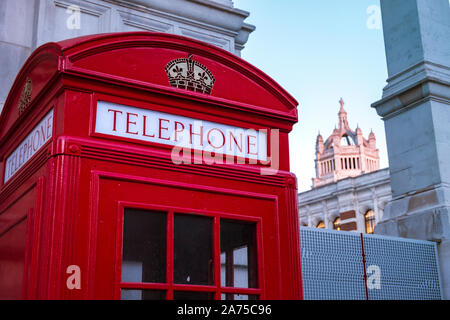 London, UK - March 19 2018: Iconic red telephone booth near the Victoria and Albert museum in sunset light Stock Photo