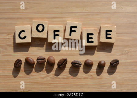 Coffee.  Word in 3d wooden alphabet letters with coffee beans on a bamboo wood background Stock Photo