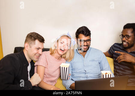 Happy diverse friends students group looking at laptop having fun