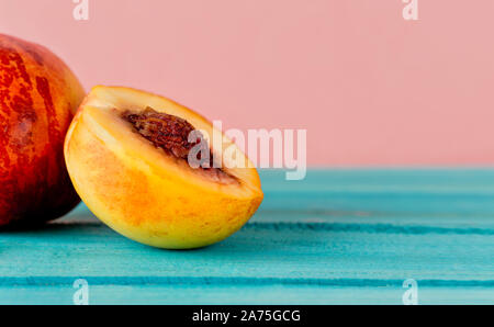 close up of peaches on black pink ground Stock Photo
