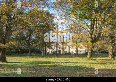 Ardgowan, Inverkip, Scotland, UK - October 26, 2019: Looking over autumn trees to the old ancient stables at Ardgowan in Inverkip Scotland with its an Stock Photo