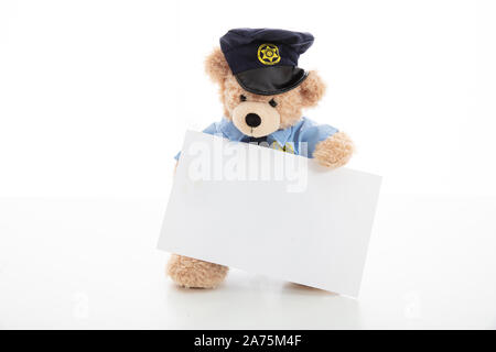 Police and security concept. Cute teddy bear in police officer uniform holding a blank card isolated against white background, copy space Stock Photo