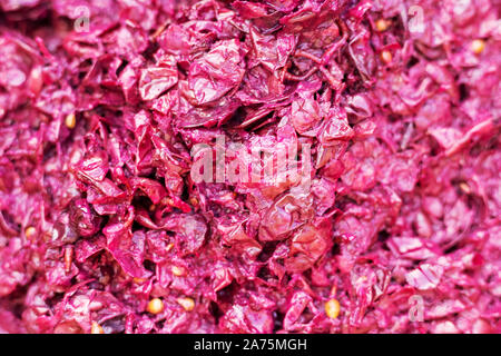 Crushed grapes in barrel fermenting. Fermentation of the pulp from berries for wine. Technology of wine production. The folk tradition of making wine. Stock Photo