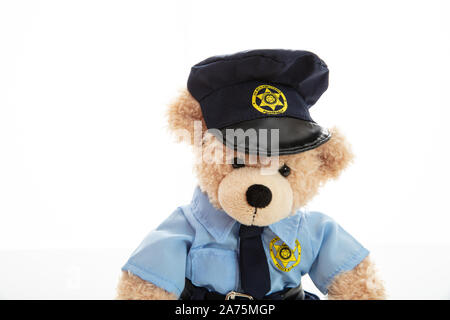 Police and security concept. Cute teddy bear in police officer uniform isolated against white background Stock Photo